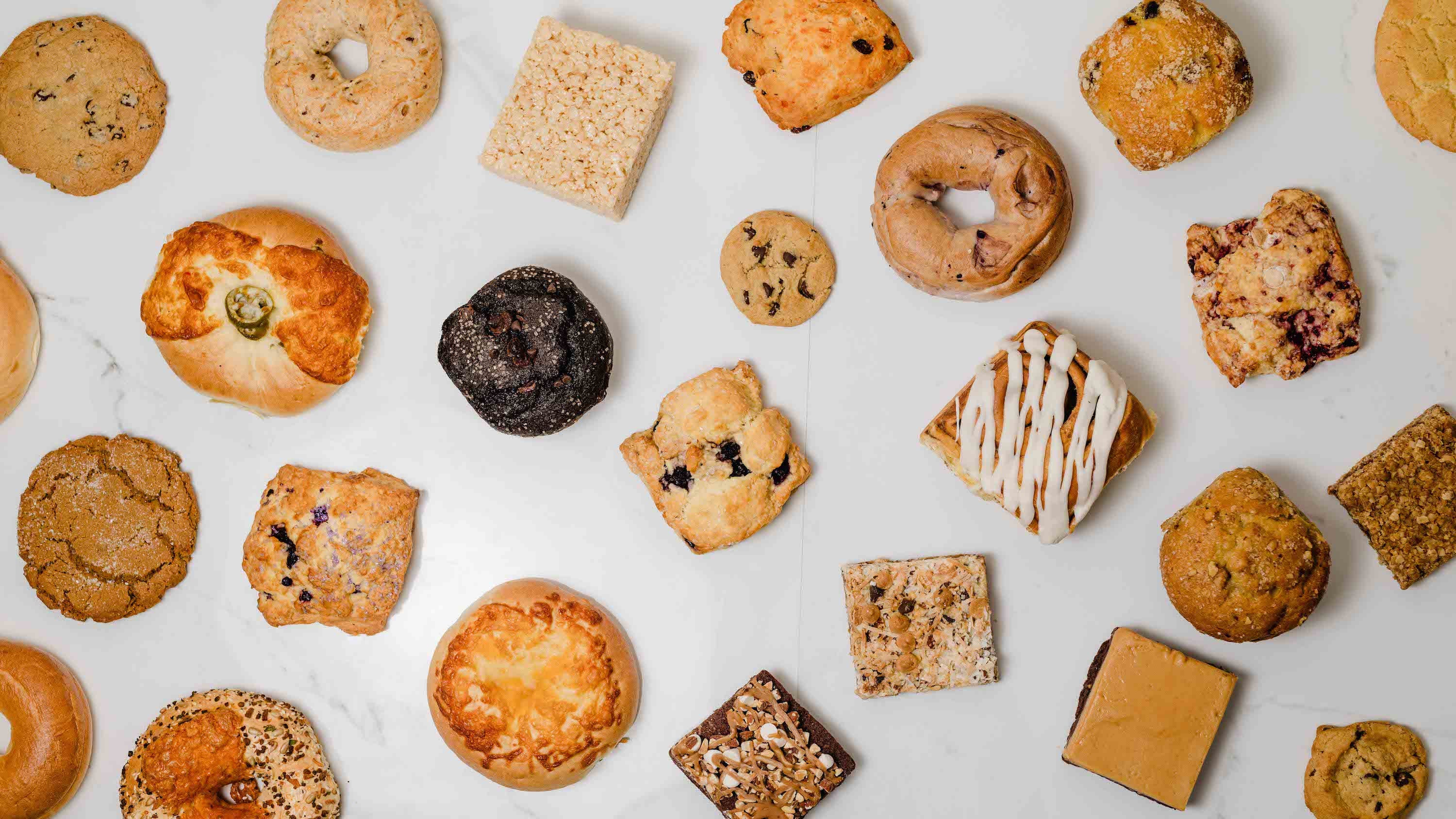 Honey Salt bagels, cookies, scones, and pastry on a marble bench